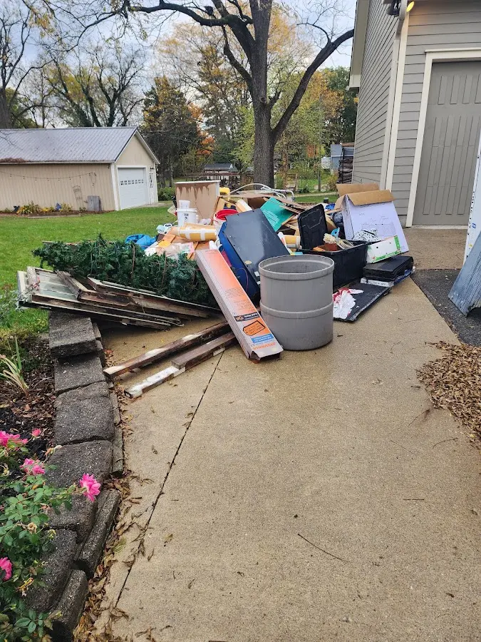 Dumpster being loaded with debris for Estate Cleanout Dumpster Rental in Lower Grand Lagoon